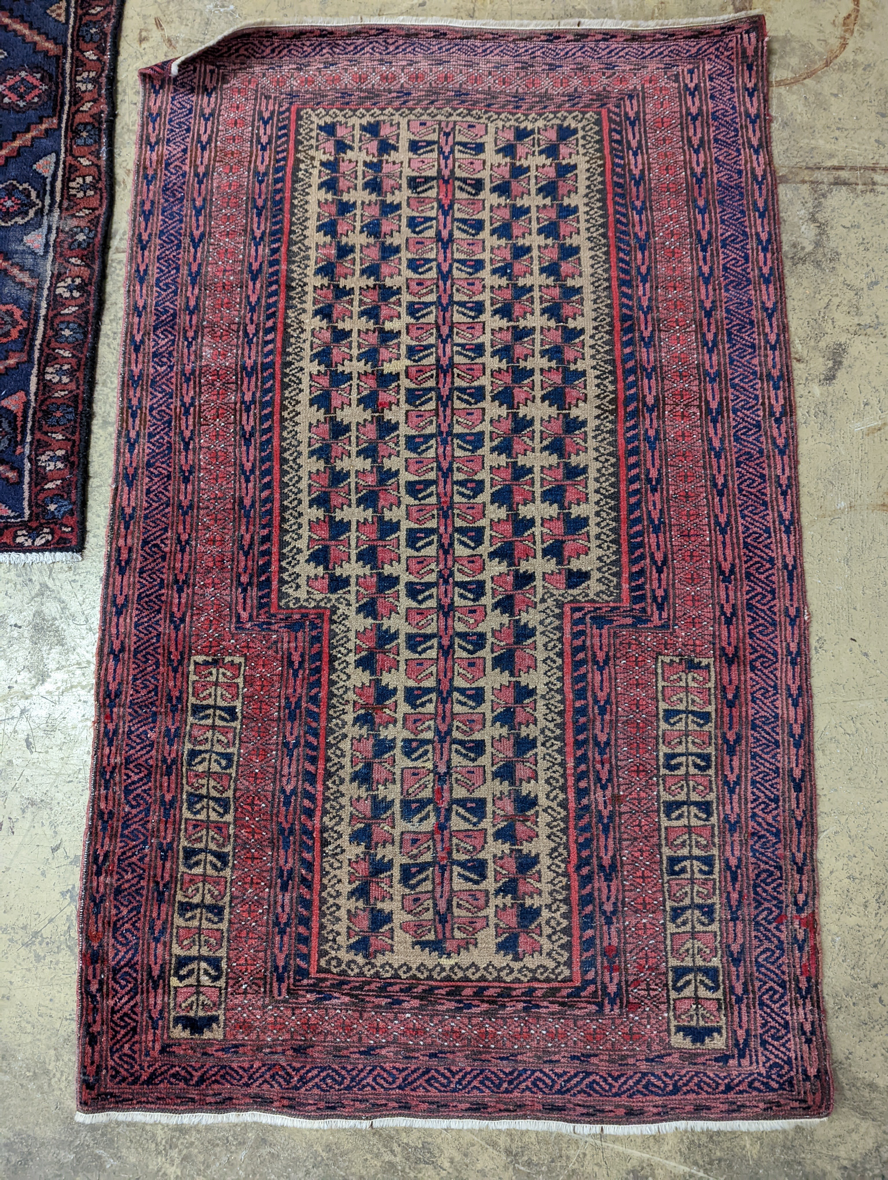 A Bokhara red ground rug and a Belouch prayer rug, larger 144 x 88cm